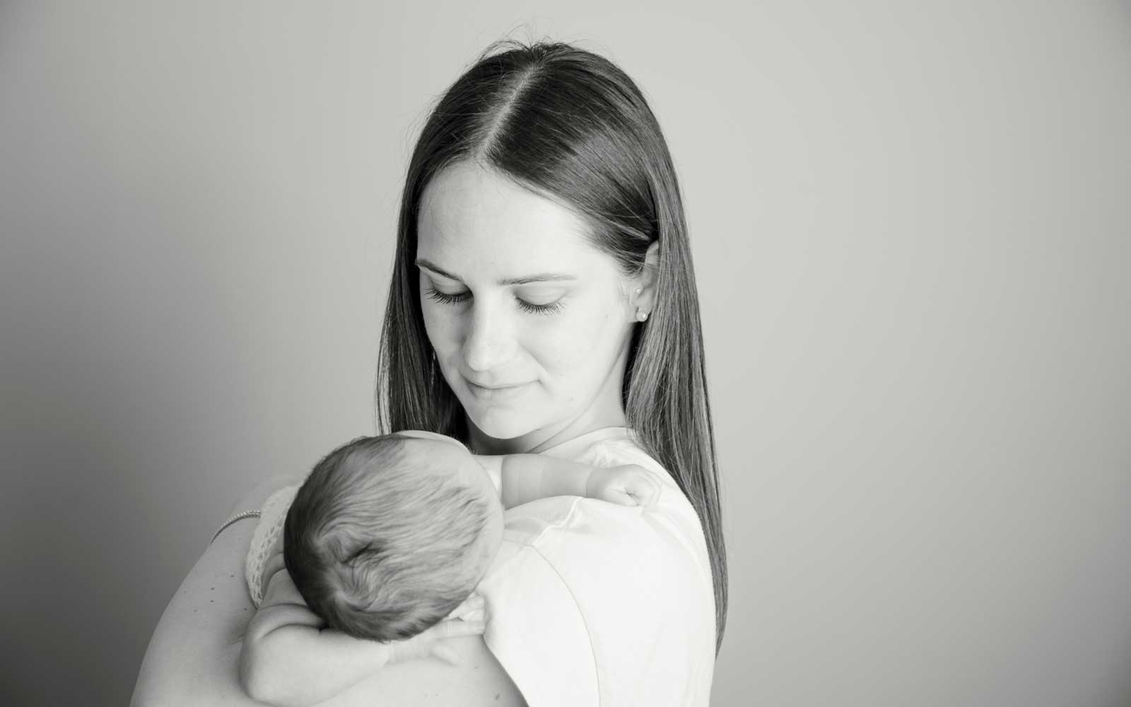 bimba appena nata in braccio alla mamma fotografata nella sala da posa fenaroli atelier